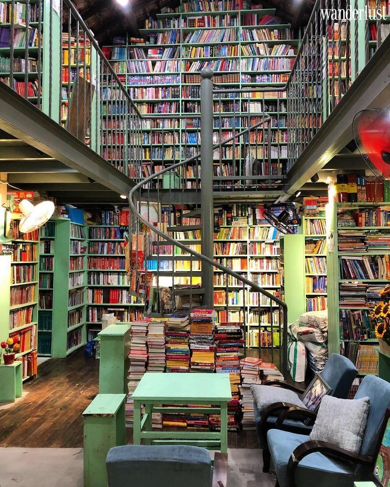 A pretty book stores with huge shelves running to the ceiling